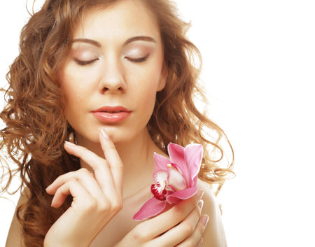 Beautiful woman with pink orchidの写真素材