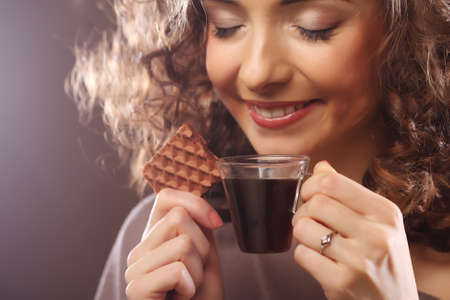 attractive woman with coffee and cookiesの写真素材