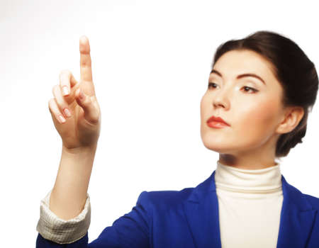 Young business woman pointing her finger on imaginery virtual buttonの写真素材