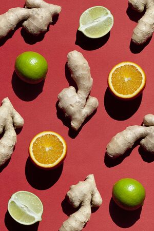 Ginger, Oranges, Limes on red background. Antioxidant Food.の写真素材