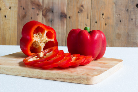 Red sweet pepper on a chopping board.の写真素材
