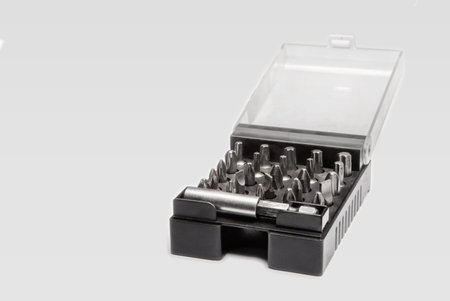 Set of screw tips in a black plastic box on white background