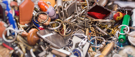 Many various colorful keychains in a box as a backgroundの写真素材