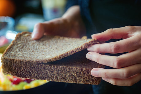 Sliced rye bread in woman hands. Close up.