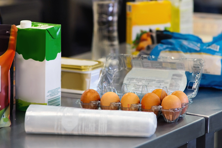 Eggs and other food on a kitchen table. Close view.の写真素材