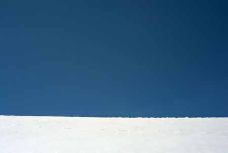 Blue sky horizon with white snow structureの写真素材