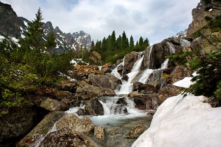 Creek in mountains, small waterfallの写真素材