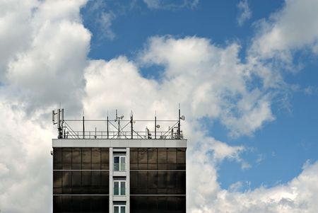 Roof of a building filled with antennas and communication devices.の写真素材