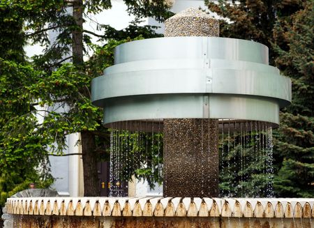 metal fountain with water in a parkの写真素材