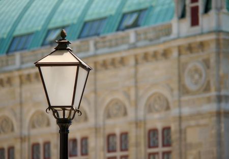 white black lamp with a historical facade in backgroundの写真素材