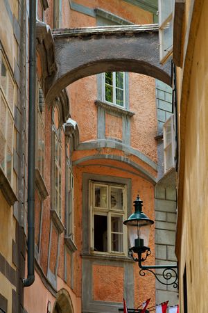 Old narrow street in a town with lampの写真素材