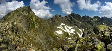 Mountain peak and ridge in summer day with boulders in foregroundの写真素材