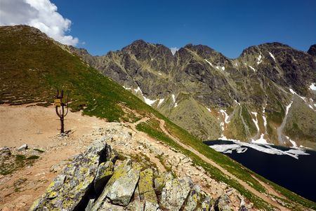 Crossroad of mountains s with partly view on a lake in summer sunny dayの写真素材