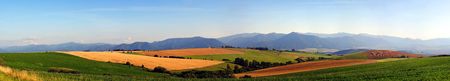 Big resolution panorama of summer meadows and fieldsの写真素材