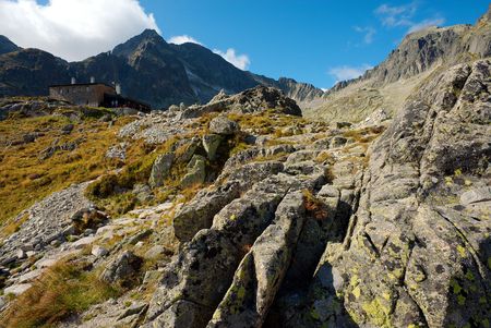 stony walking path to a mountain cottage in summer dayの写真素材