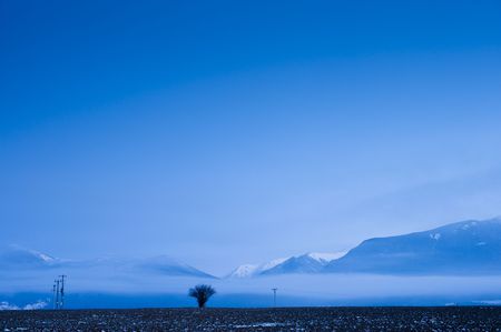 Mountains horizon in morning with electric columnsの写真素材