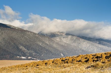 plough field and mountains in suny dayの写真素材
