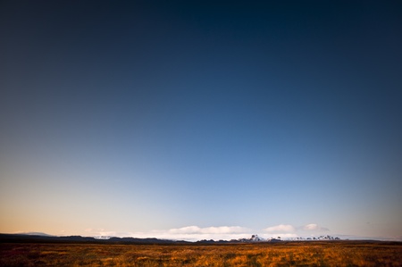 Low horizon with mountains in sunsetの写真素材