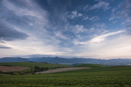 meadows in sunset with pink clouds on the skyの写真素材
