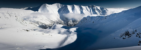 Mountains winter panorama in white and blue
