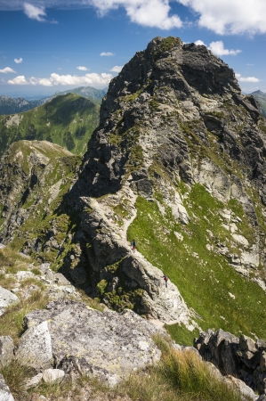 walking steep mountains ridge in summer sunny dayの写真素材