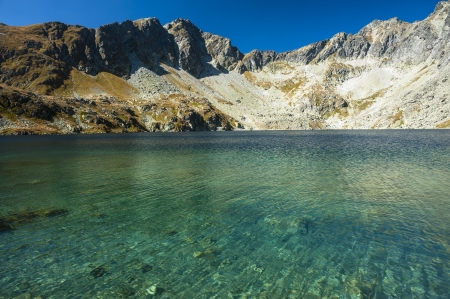 A mountain lake with pure water in sunny dayの写真素材