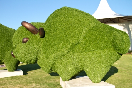 Statue of a bull with artificial green grassの写真素材