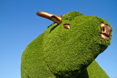 Statue of a bull with artificial green grassの写真素材