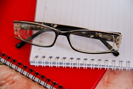 Glasses, notebook, pencil