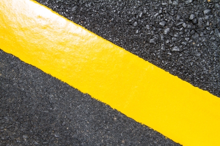 Yellow line on new asphaltの写真素材