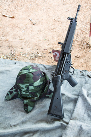 rifle with military helmet