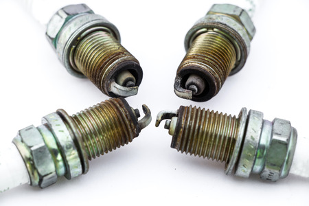 old burned spark plugs isolated on white backgroundの写真素材