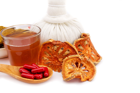 Dried Bael, Beal tea and capsule on white backgroundの写真素材