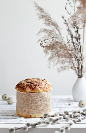 Easter yeast bread or cake with willow sprigs on the table.