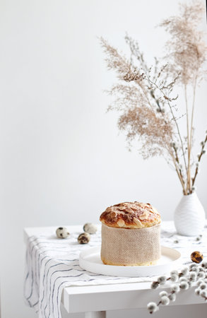 Easter yeast bread or cake with willow sprigs on the table.
