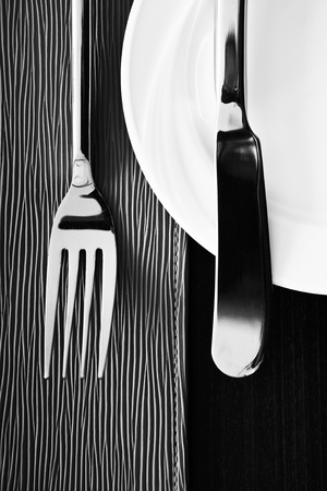 Knife, fork and plate on texture  backgroundの写真素材