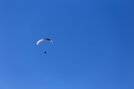 Paraglider in clear blue skyの写真素材
