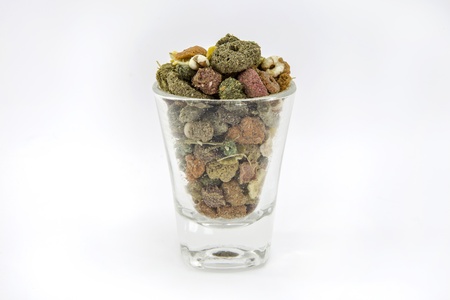 Pet food for guinea pigs or cavy in the glass on white backgroundの写真素材