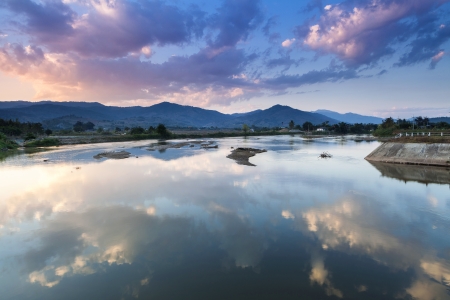 sky reflection on water in sunset at mae chaem reservoir, Chiang Mai, Thailandの写真素材