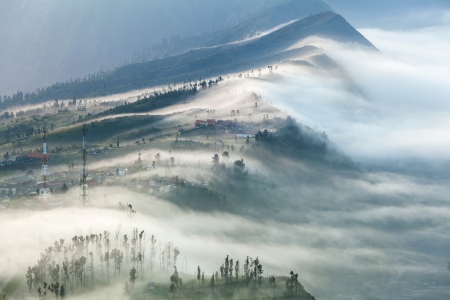 The mist cover the village at Bromo Volcano Mountain in Tengger Semeru National Park, East Java, Indonesiaの写真素材