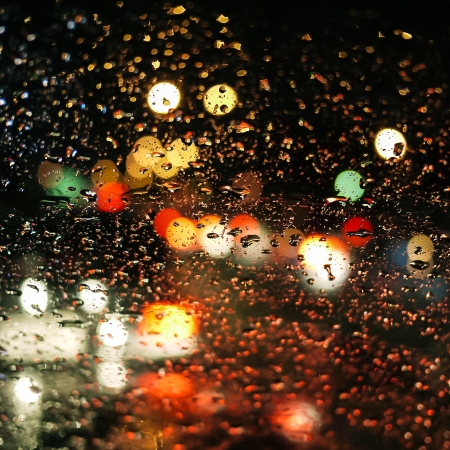 rain drops on car glass in rainy nightの写真素材