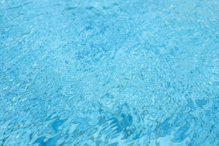 Blue pool water and sun reflectionsの写真素材