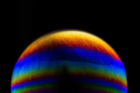 Close up of colorful soap bubble abstract over black backgroundの写真素材