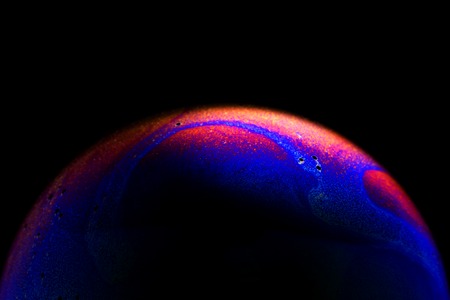 Close up of colorful soap bubble abstract over black backgroundの写真素材