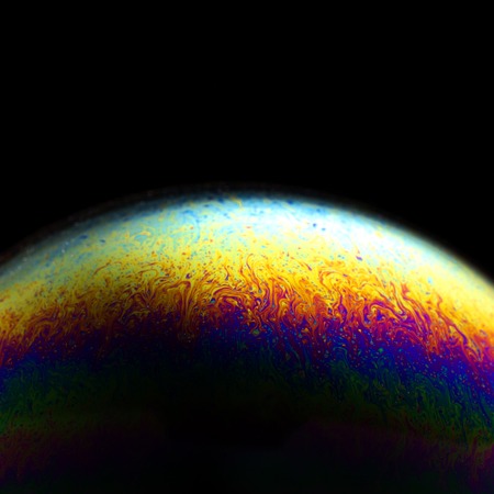 Close up of colorful soap bubble abstract over black backgroundの写真素材