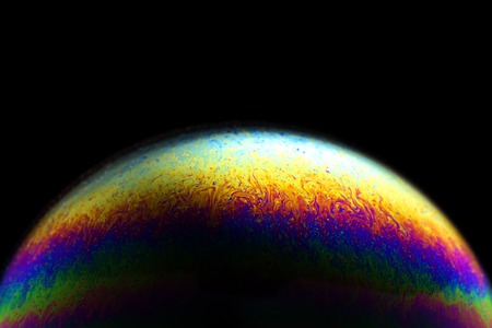 Close up of colorful soap bubble abstract over black backgroundの写真素材