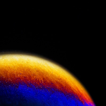 Close up of colorful soap bubble abstract over black backgroundの写真素材