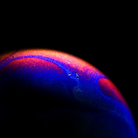 Close up of colorful soap bubble abstract over black backgroundの写真素材