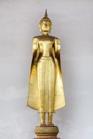 Thai Standing  Golden Buddha in the temple of Thailandの写真素材