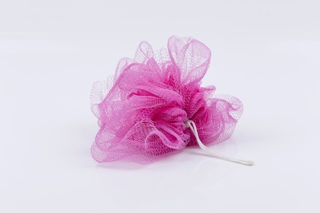 pink bath puff or sponge on white backgroundの写真素材